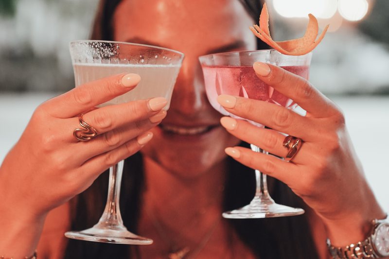 Friends raising cocktail glasses at Starlight Beach Bar