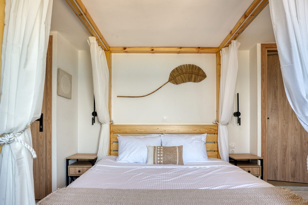 Penthouse room at Starlight Ocean View with a four-poster bed and large sea-view terrace