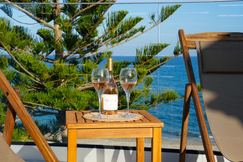Bottle of rosé and two glasses on the Penthouse terrace above the Aegean
